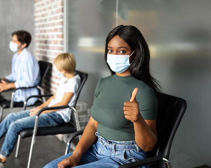 woman giving a thumbs up in a waiting room