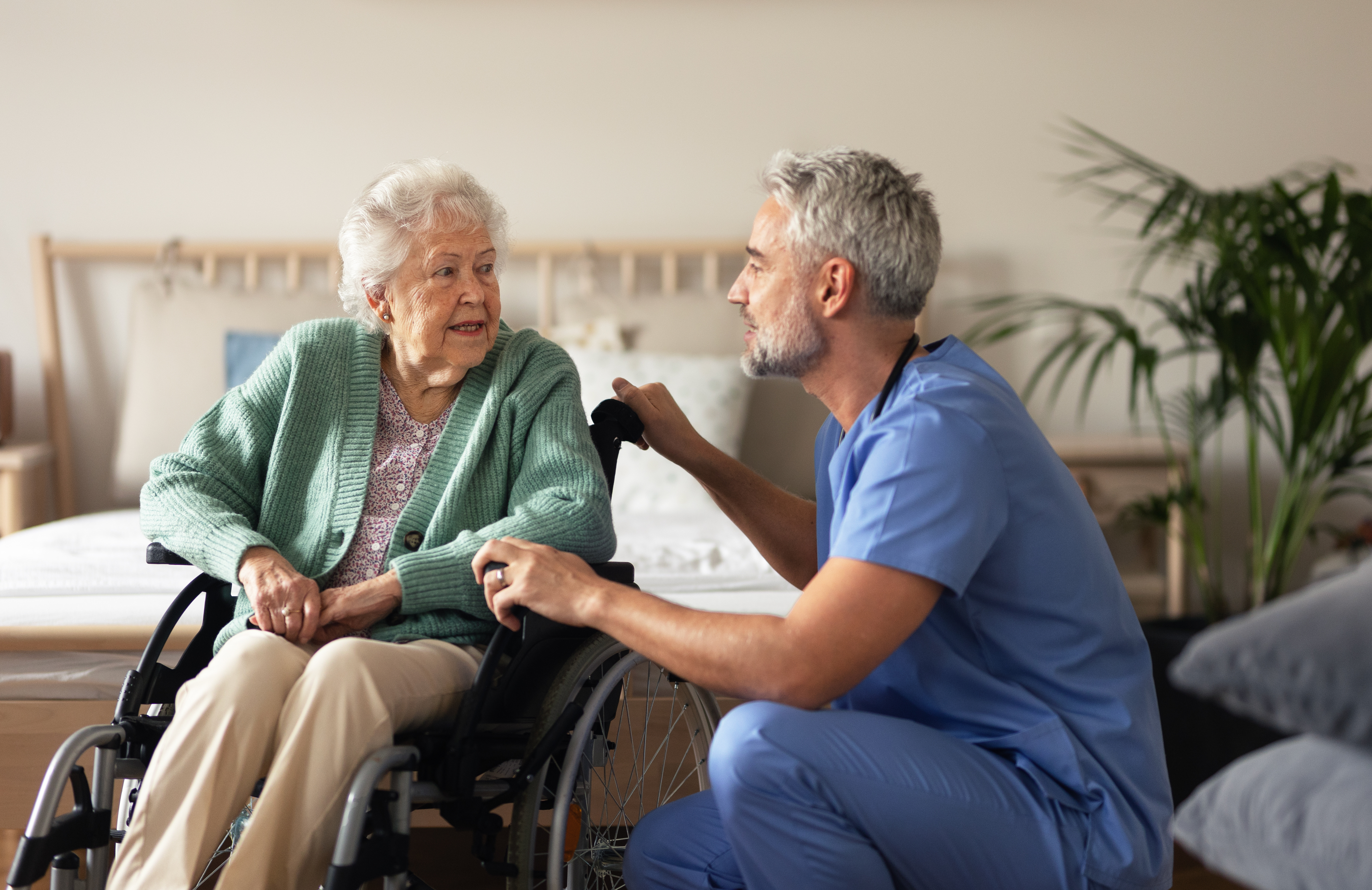 Caregiver doing regular check-up of senior woman in her home