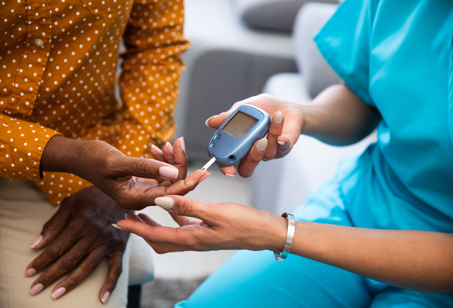 lady getting her blood sampled via her index finger