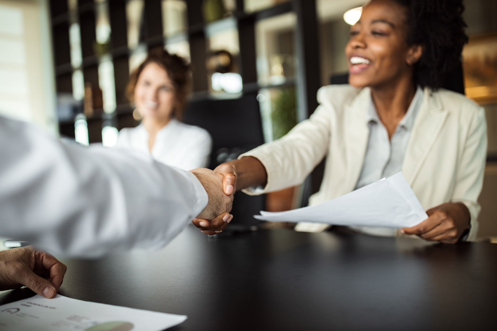 a welcoming career lady shaking hands