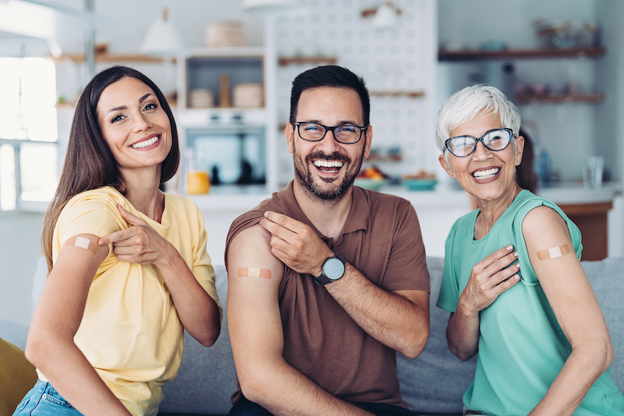 a woman, man, and elder with their band-aids